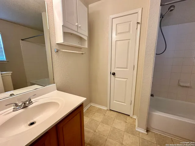 a bath tub sitting next to a white toilet and a shower