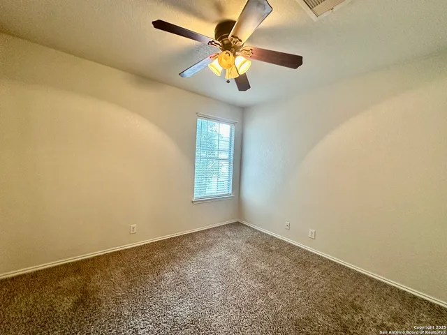 a view of room window and ceiling fan