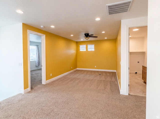 1251 North 2525 West Clinton, UT 84015 - Photo 11 of 30 Spacious carpeted room featuring recessed lighting, a ceiling fan, and two windows