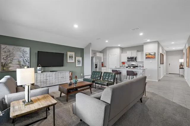 a living room with furniture and a large window