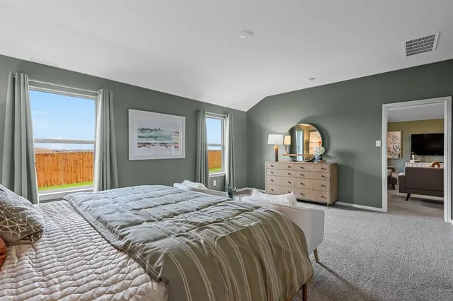 a bedroom with a bed and window