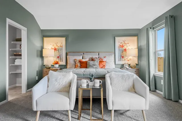 a bedroom with a bed a mirror and dresser