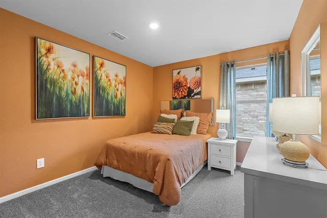 a bedroom with a bed and a large window