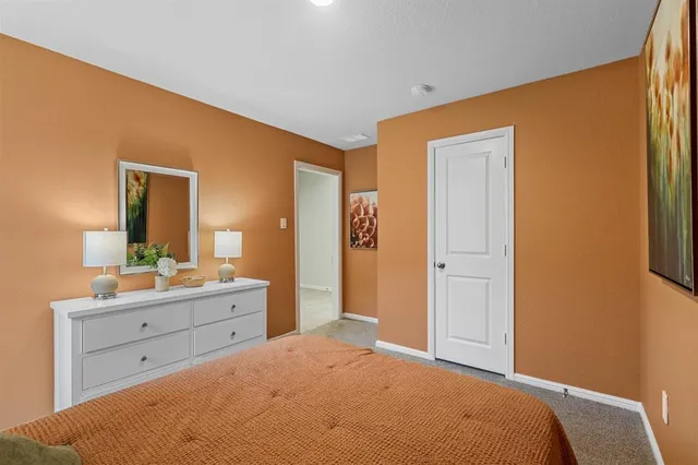 a bedroom with a bed and a dresser in it