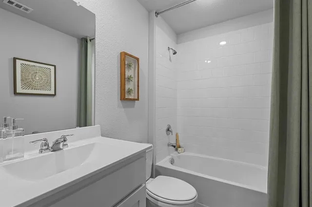 a bathroom with a toilet a sink and bathtub