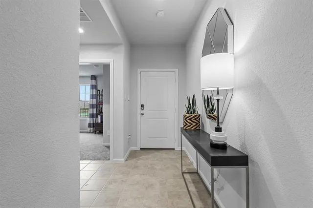 a hallway with a sink and a mirror