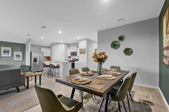 a dining room with furniture and window