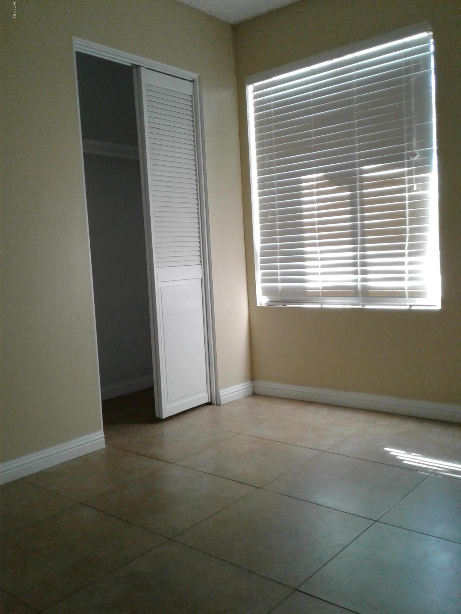 8416 West Roma Avenue Phoenix, AZ 85037 - Photo 14 of 33 a view of an empty room with a window