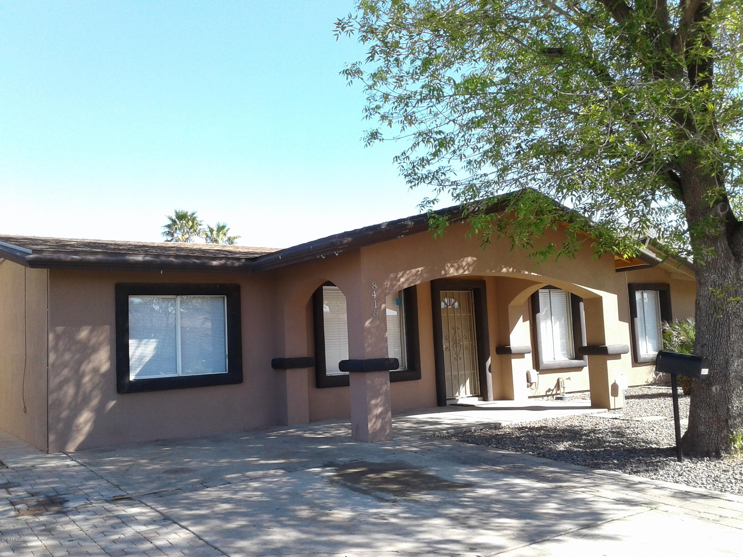 8416 West Roma Avenue Phoenix, AZ 85037 - Photo 2 of 33 a front view of a house with a yard and garage