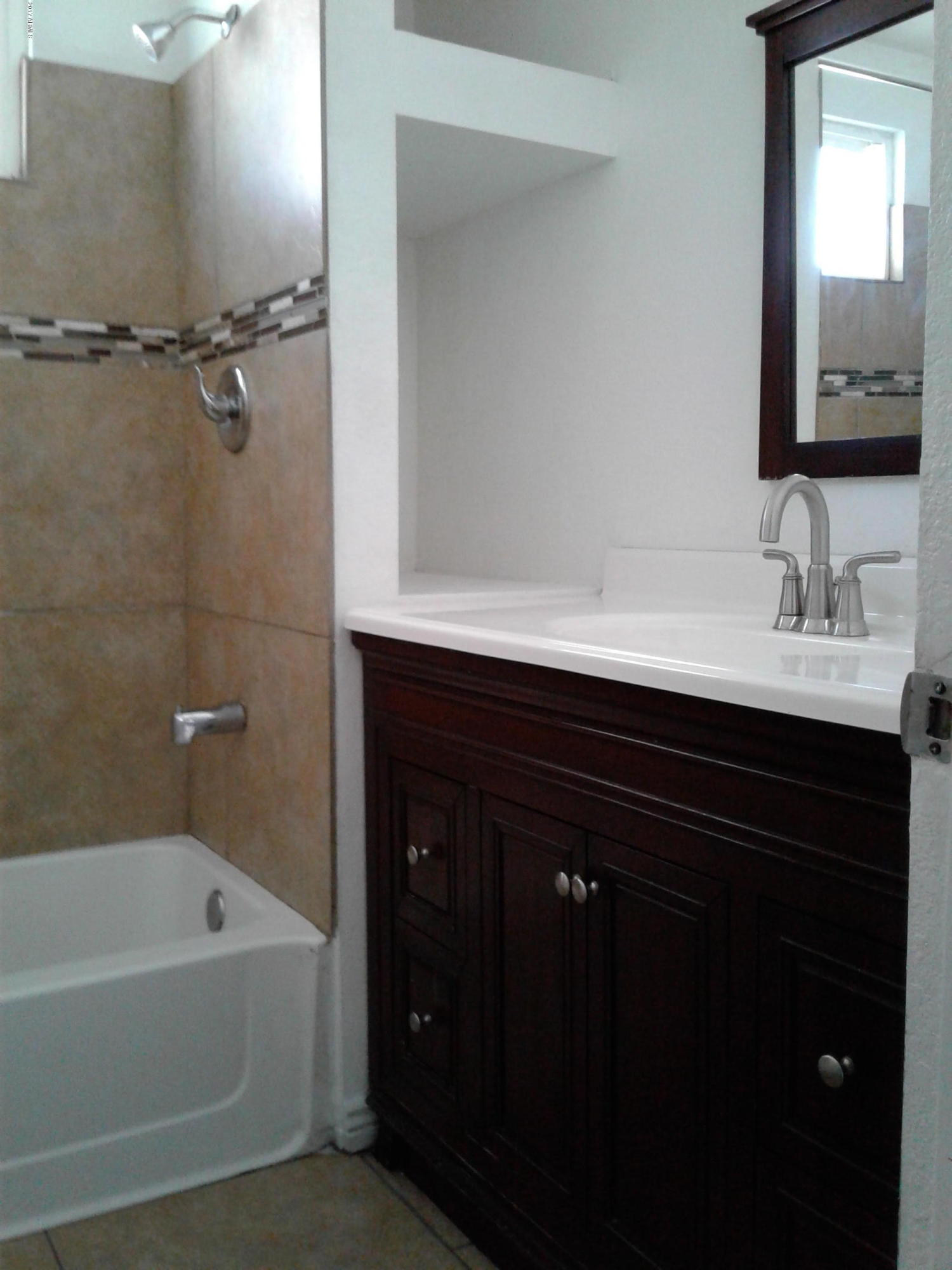 8416 West Roma Avenue Phoenix, AZ 85037 - Photo 21 of 33 a bathroom with a bathtub sink vanity and mirror