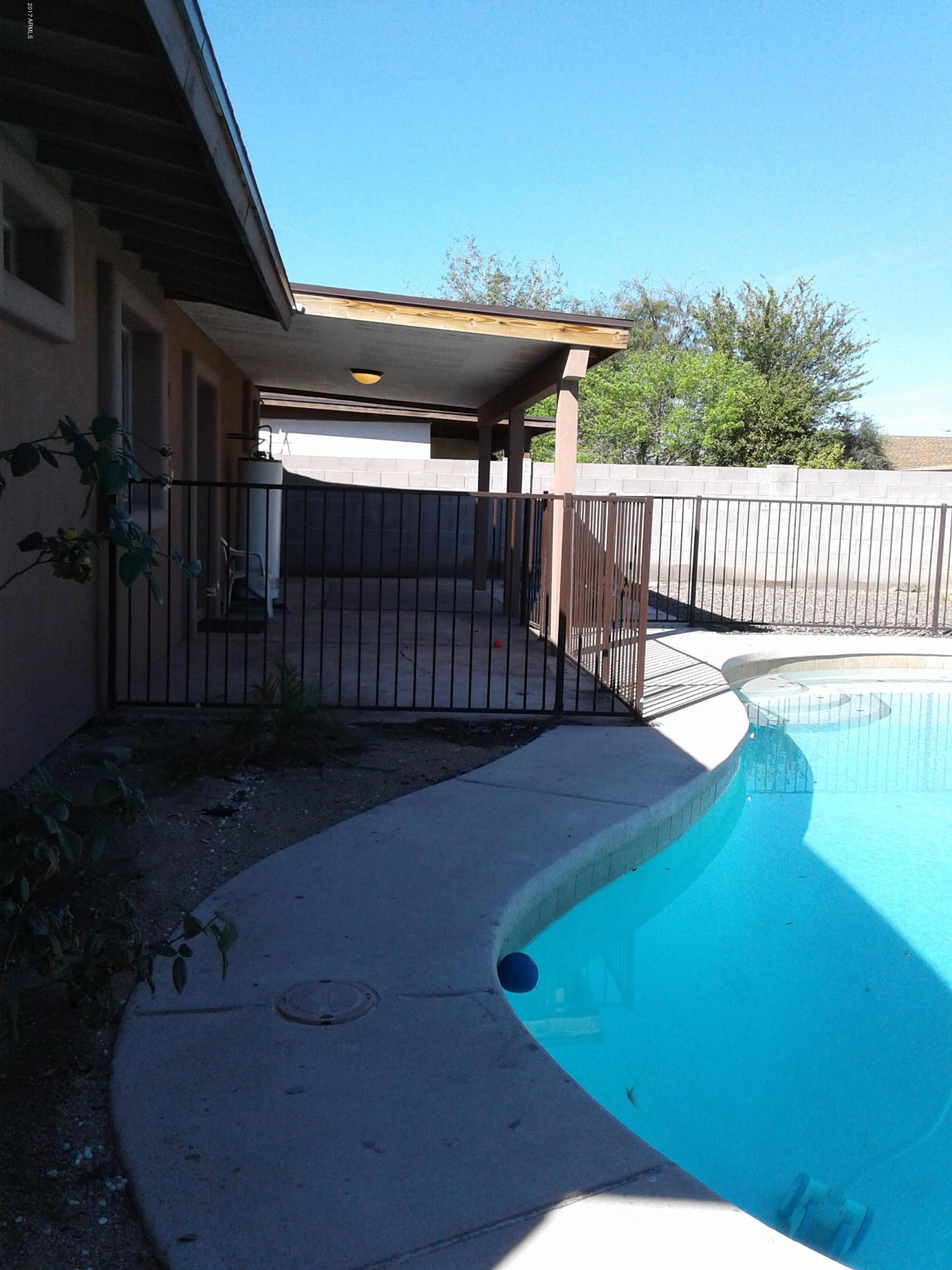 8416 West Roma Avenue Phoenix, AZ 85037 - Photo 22 of 33 a view of a porch with a backyard