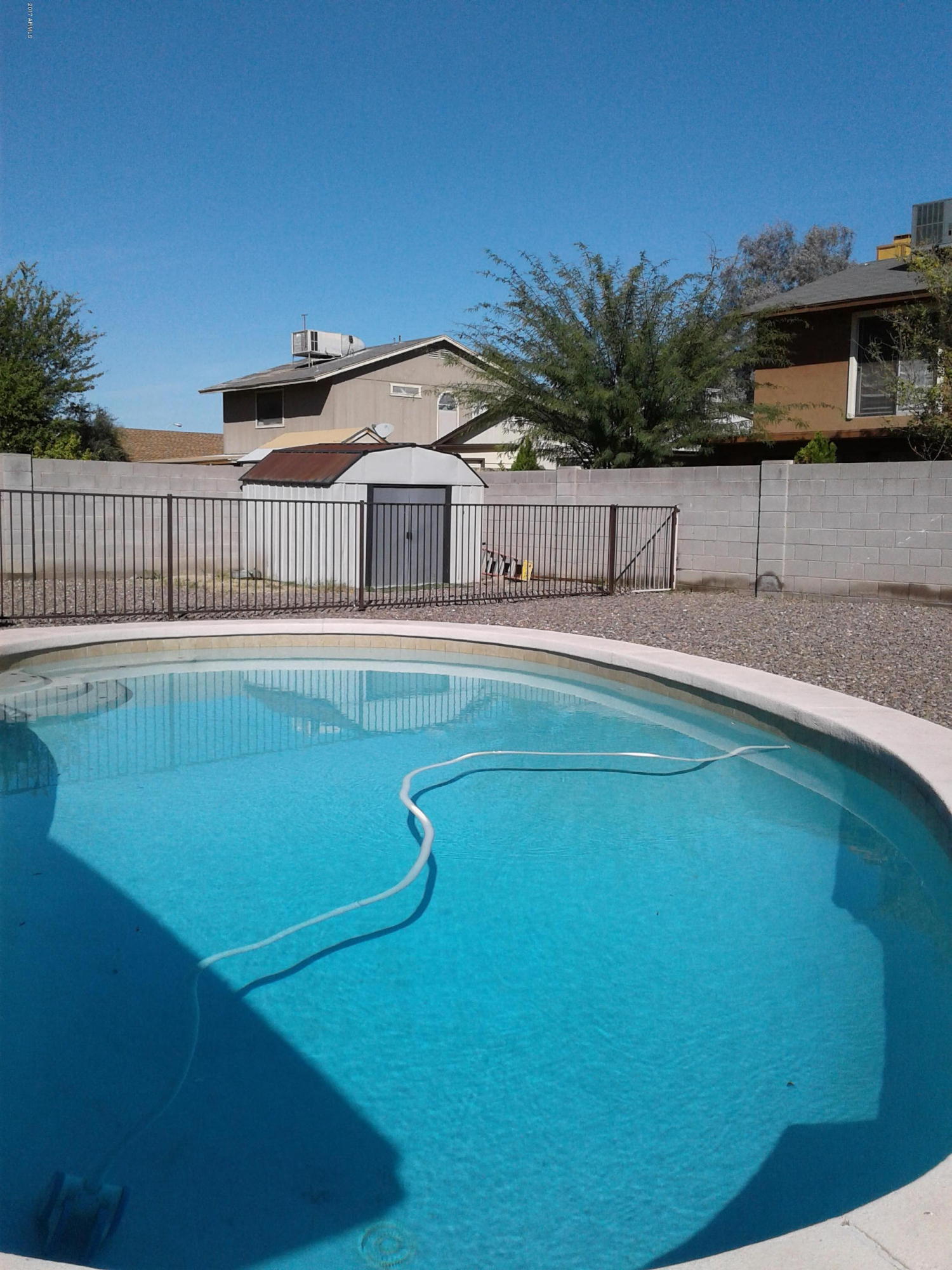 8416 West Roma Avenue Phoenix, AZ 85037 - Photo 24 of 33 a front view of a house with a yard