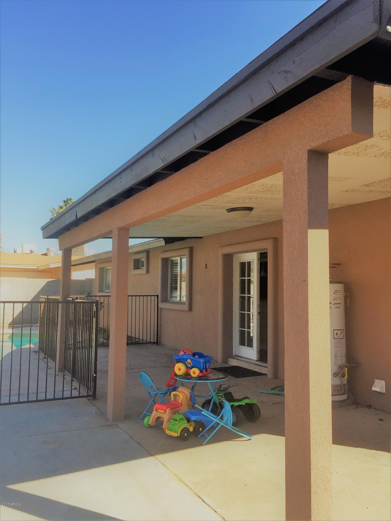 8416 West Roma Avenue Phoenix, AZ 85037 - Photo 32 of 33 a front view of a house with patio