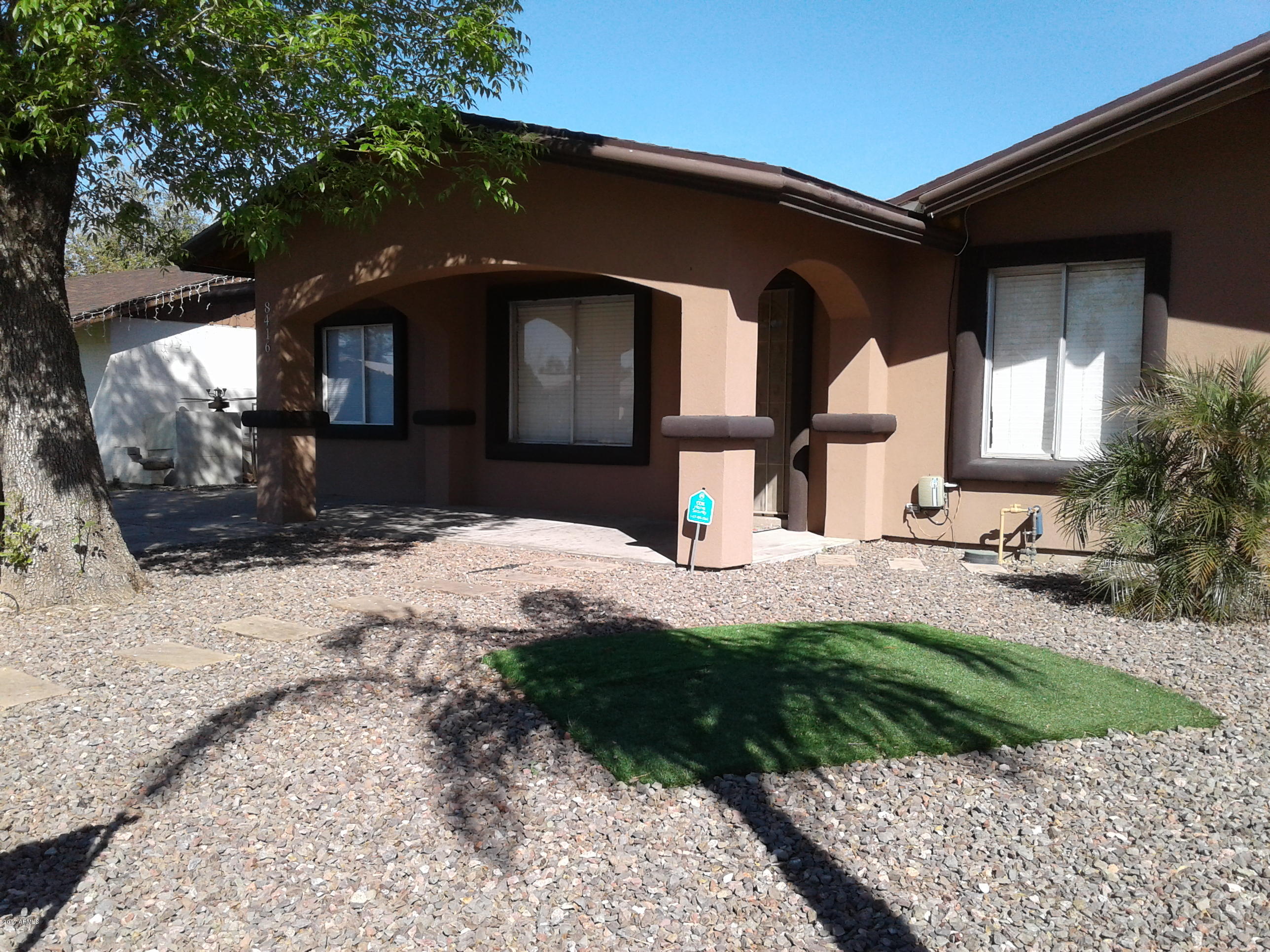 8416 West Roma Avenue Phoenix, AZ 85037 - Photo 4 of 33 a front view of a house with a yard