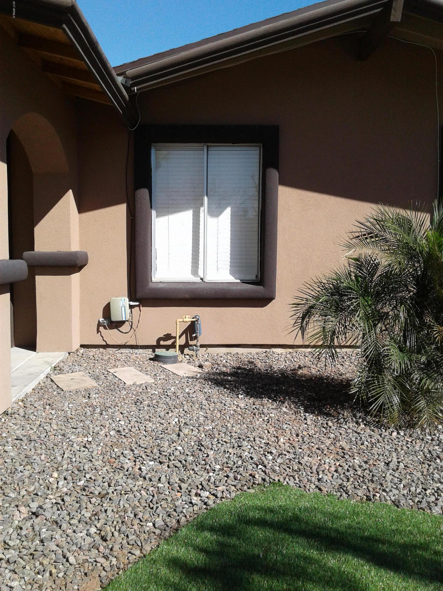 8416 West Roma Avenue Phoenix, AZ 85037 - Photo 5 of 33 a front view of a house with a yard