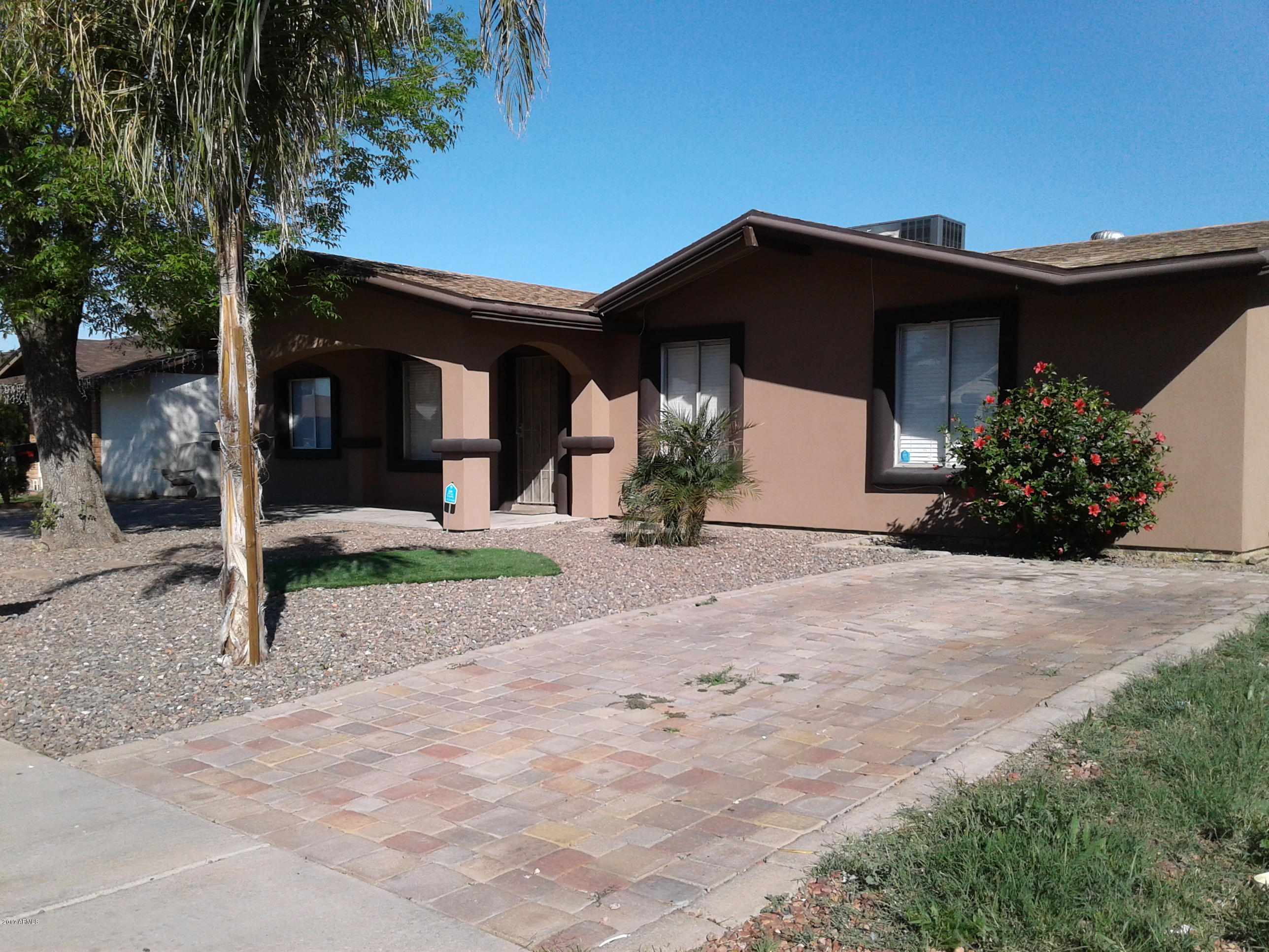 8416 West Roma Avenue Phoenix, AZ 85037 - Photo 6 of 33 a front view of a house with a yard and garage
