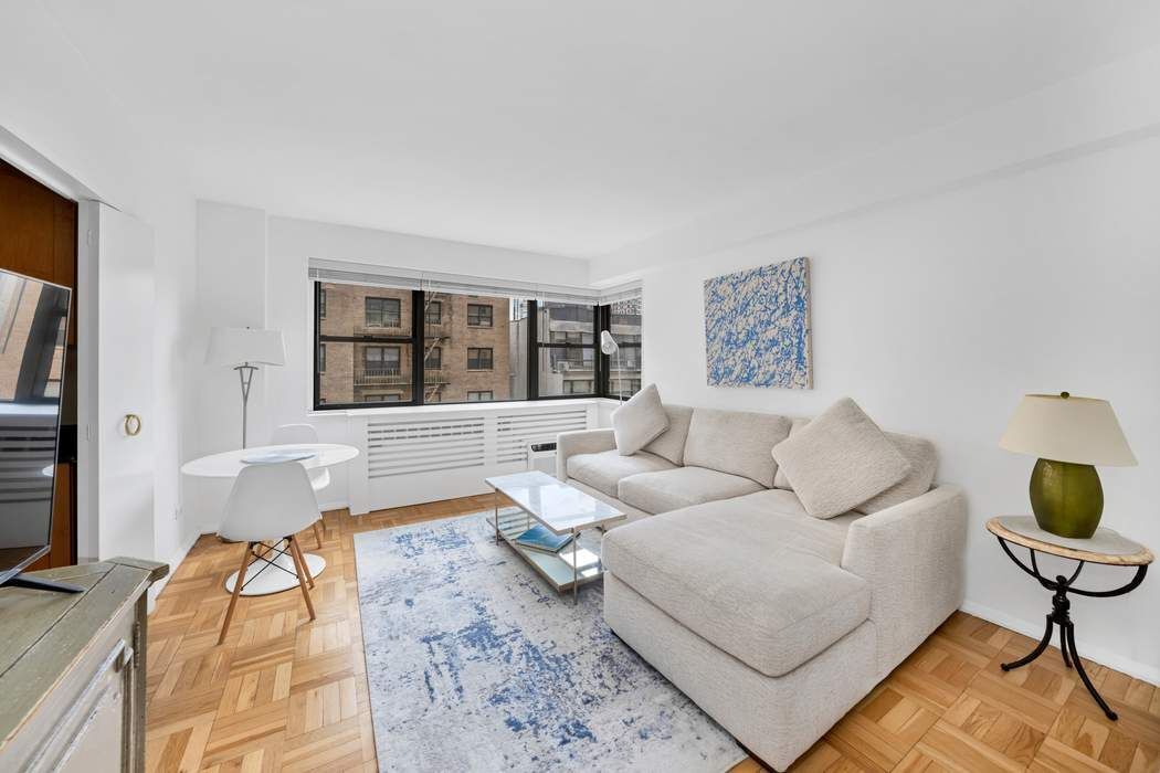 305 East 72nd Street, Unit 5AS Manhattan, NY 10021 - Photo 2 of 11 a living room with furniture and a window
