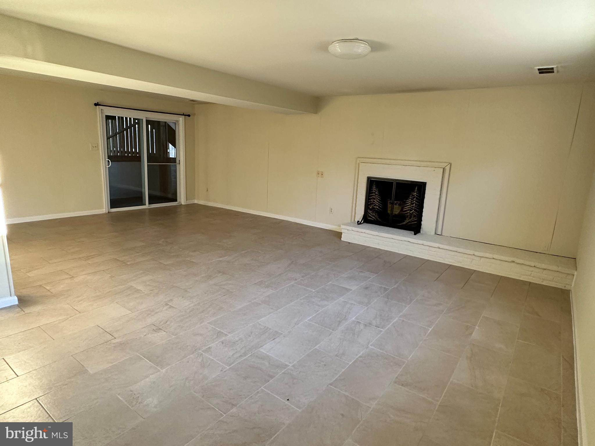 8722 Postoak Road Potomac, MD 20854 - Photo 30 of 33 Rec Room w/ exit to the backyard and Firplace