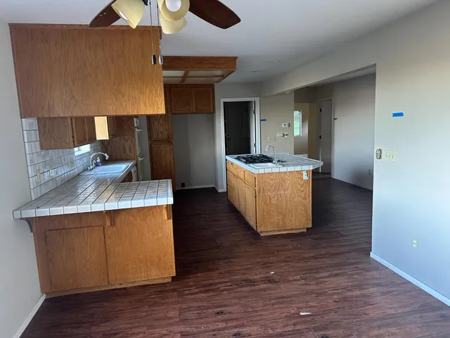 a living room with kitchen island furniture and a wooden floor