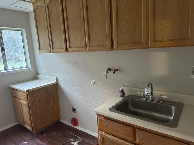 a kitchen with a sink cabinets and window