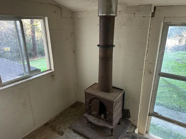 a living room with a floor to ceiling window and a fireplace