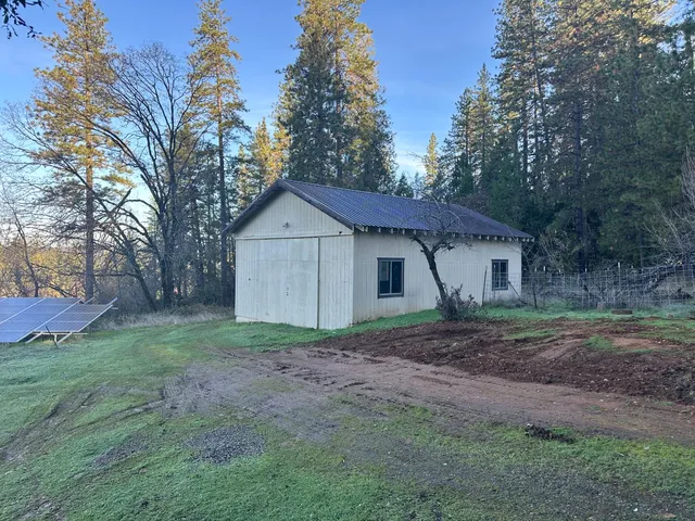 a view of a house with yard and a tree