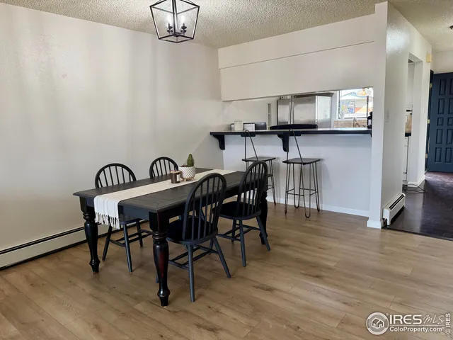 a bedroom with a large bed and a flat tv screen on dresser