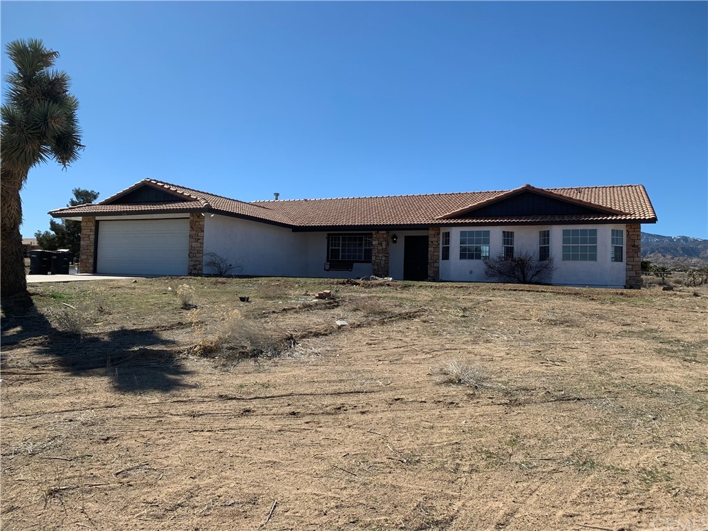 9680 Centola Road Phelan, CA 92371 - Photo 1 of 1 a front view of a house with a yard