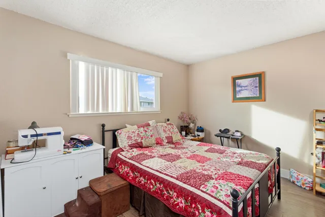 a bedroom with a bed and a table in it