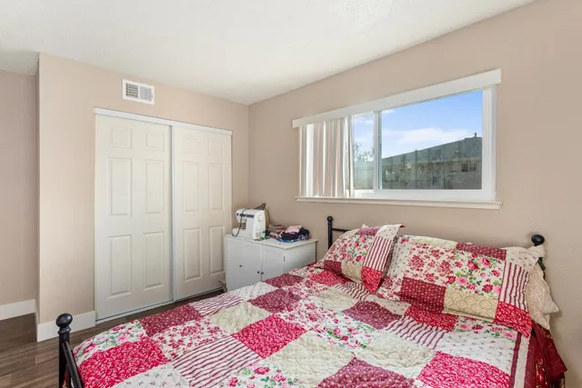a bedroom with a bed and a painting on the wall