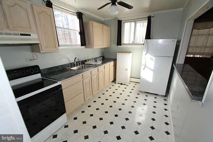 500 Whitaker Mill Road Fallston, MD 21047 - Photo 3 of 14 a kitchen with granite countertop a refrigerator a stove a sink a washer and dryer