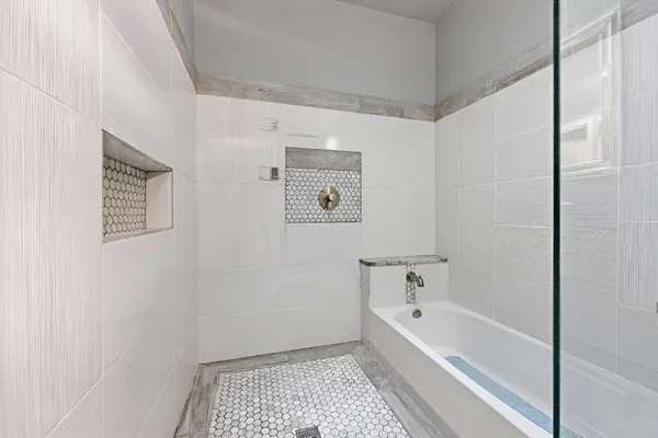 a bathroom with a sink toilet vanity and shower