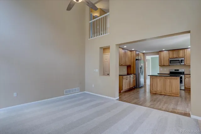 a view of a kitchen with wooden floor and electronic appliances
