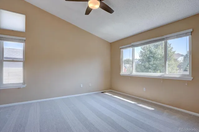 a view of an empty room with window and a chandelier