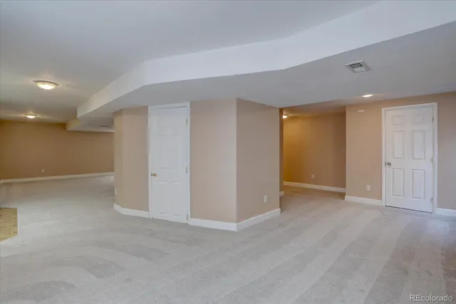 an empty room with furniture and a window