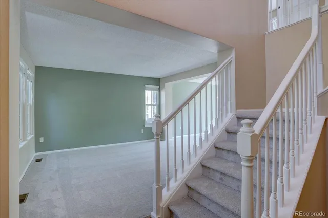 a view of an empty room with stairs