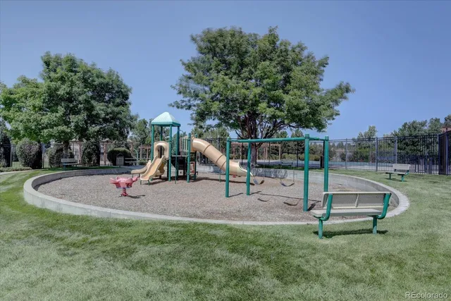 a view of a backyard with wooden fence