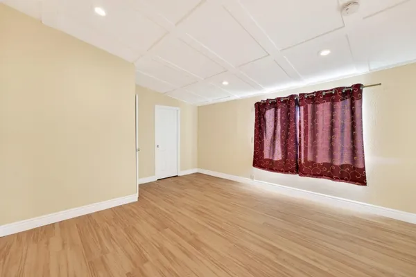 an empty room with wooden floor and closet