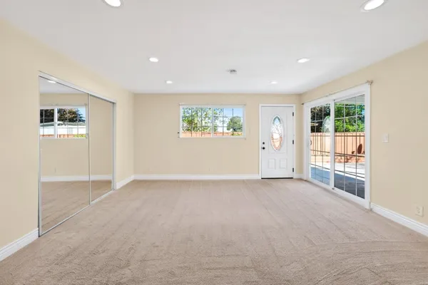 an empty room with windows and closet