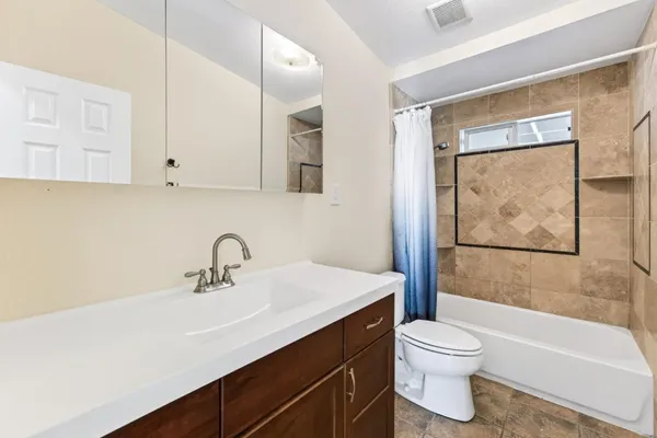 a bathroom with a sink mirror toilet and bathtub