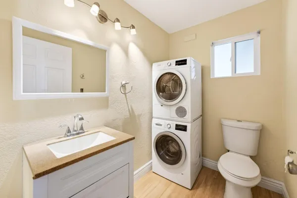 a bathroom with a sink mirror and toilet