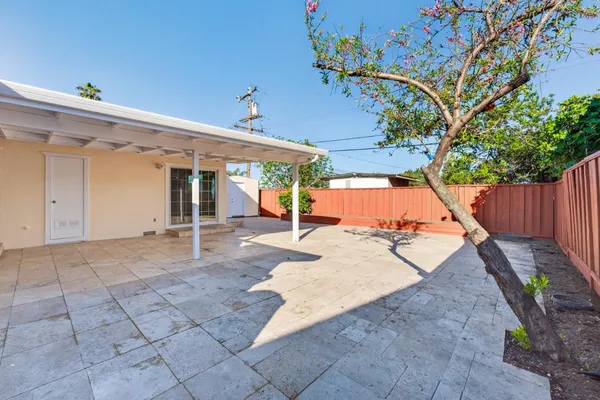 a view of a backyard with a patio and entertaining space