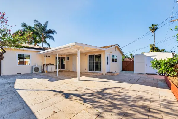 a view of a white house with a yard