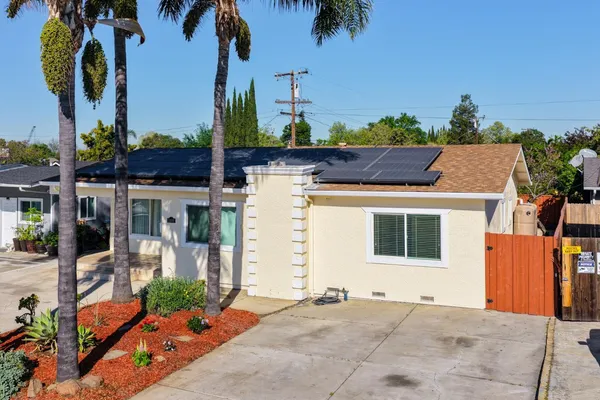 a view of a patio with table and chairs and potted plants