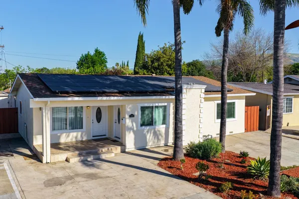 an aerial view of multiple houses with a yard