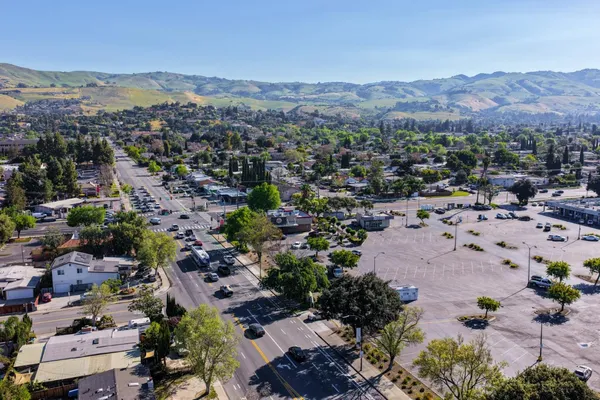 an aerial view of a house with garden space and a street view