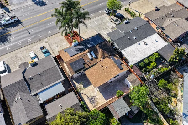 an aerial view of a house with large trees