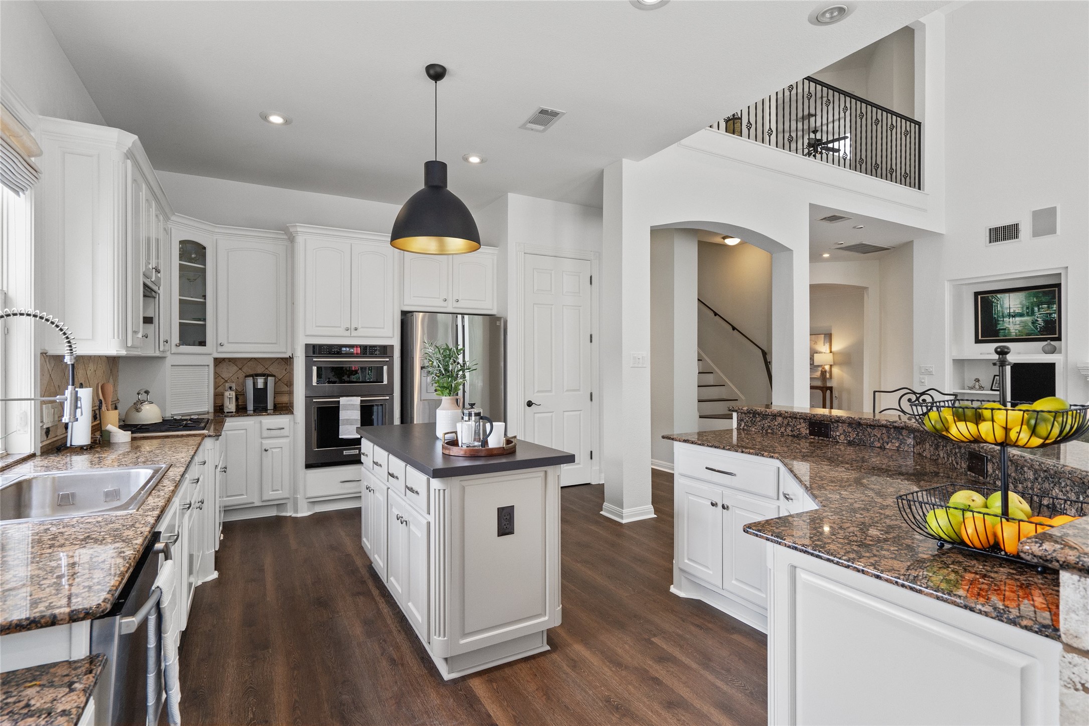4313 Rio Robles Drive Austin, TX 78746 - Photo 13 of 40 A grand, open-concept kitchen with an inviting island and elegant granite countertops.