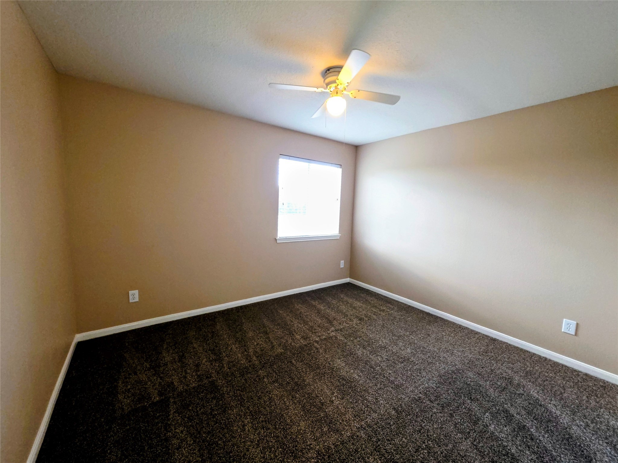 24235 Stargazer Point Spring, TX 77373 - Photo 15 of 21 an empty room with a window and chandelier fan