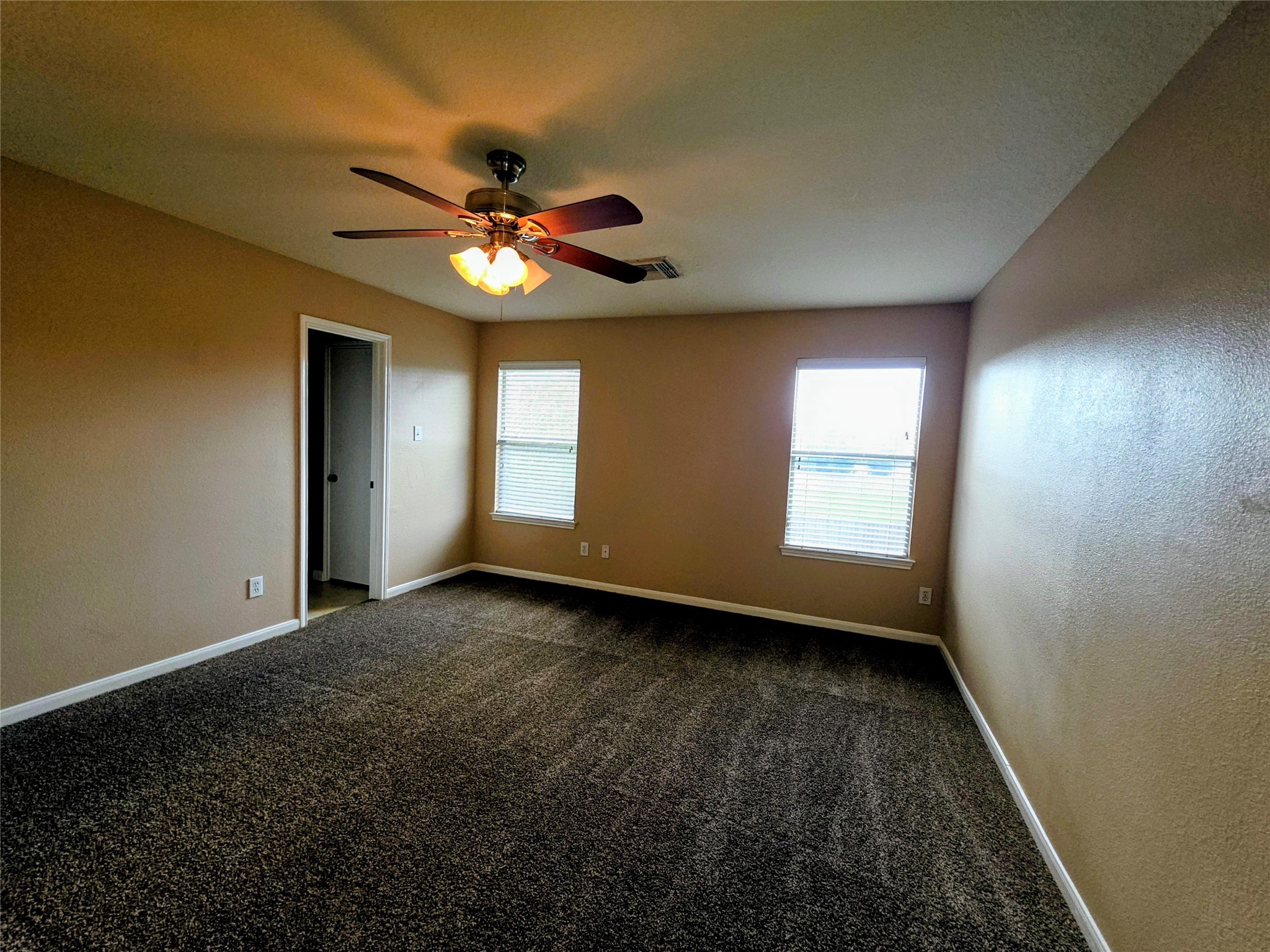 24235 Stargazer Point Spring, TX 77373 - Photo 17 of 21 a view of an empty room with window and chandelier fan
